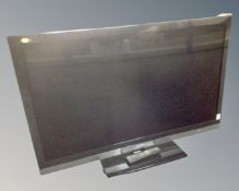 A Sharp Aquos 48" LCD TV with remote.