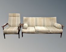 A mid 20th century teak framed three seater settee and manual reclining armchair