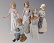 A group of five Nao figures of children.