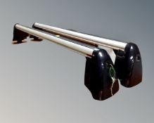 A pair of car roof bars with keys.