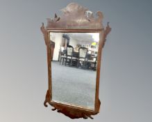 A Georgian style carved and gilt mirror.