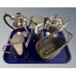 A tray containing silver plated teapots and a similar basket.