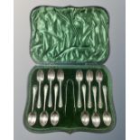 A set of twelve cased silver teaspoons with tongs,