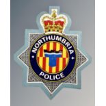 A plywood Northumbria Police crest.