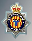 A plywood Northumbria Police crest.