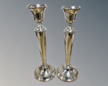 A pair of loaded silver candlesticks, marks rubbed, height 29.5cm.