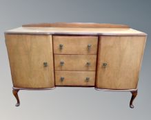A 20th century six piece Queen Anne style dining room suite comprising of double door inverted