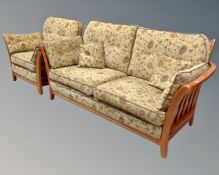 An Ercol wood framed four piece lounge suite comprising of a two seater settee,