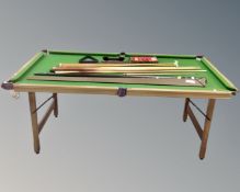 A Hayward De Luxe 6' folding snooker table with cues balls and accessories.