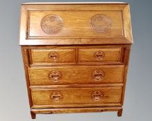 A Chinese hardwood secretaire bureau fitted with four drawers beneath (width 92cm)