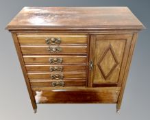An Edwardian mahogany seven drawer music cabinet fitted with a cupboard.