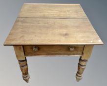 A 19th century pine farmhouse kitchen table fitted with a drawer (length 104cm)