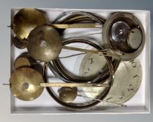 A tray containing antique and later clock pendulums including brass examples,