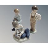 Three Nao figures, Boy with Rabbit, Boy with Train and Boy with Football.
