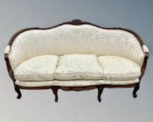 A French carved walnut framed three seater settee in a two tone oyster silk fabric (width 200cm)