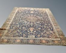 A machined Persian design carpet on blue ground, 365cm by 276cm.