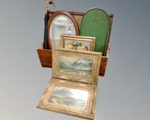 A wooden storage chest containing gilt framed pictures, an Edwardian oak framed mirror,