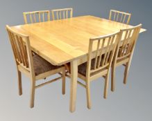 A contemporary oak extending dining table (length 165cm) with a set of six matching rail back