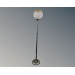 An Art Deco chrome adjustable standard lamp with opaque glass shade.
