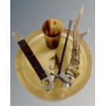 A resin ashtray inset with a fishing fly together with two cigar cutters,