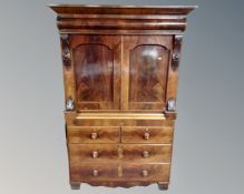 A Victorian mahogany linen press fitted with four drawers beneath (width 126cm)