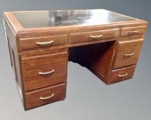 A 20th century mahogany twin pedestal desk fitted with seven drawers (width 124cm)