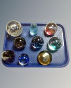 A tray of nine glass paperweights to include Caithness and commemorative examples