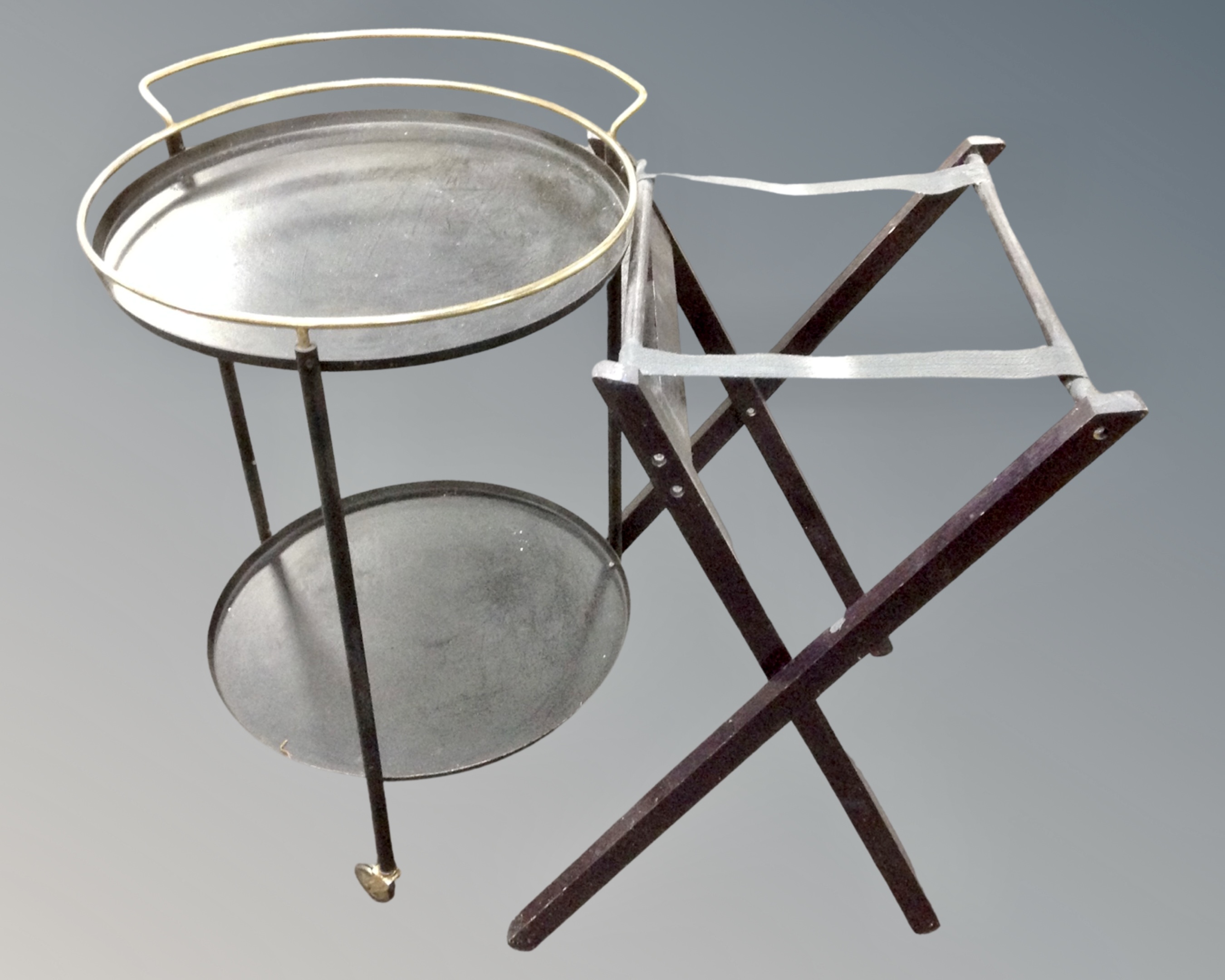 A 20th century circular metal two tier drinks trolley together with a folding luggage stand.