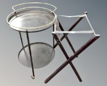 A 20th century circular metal two tier drinks trolley together with a folding luggage stand.