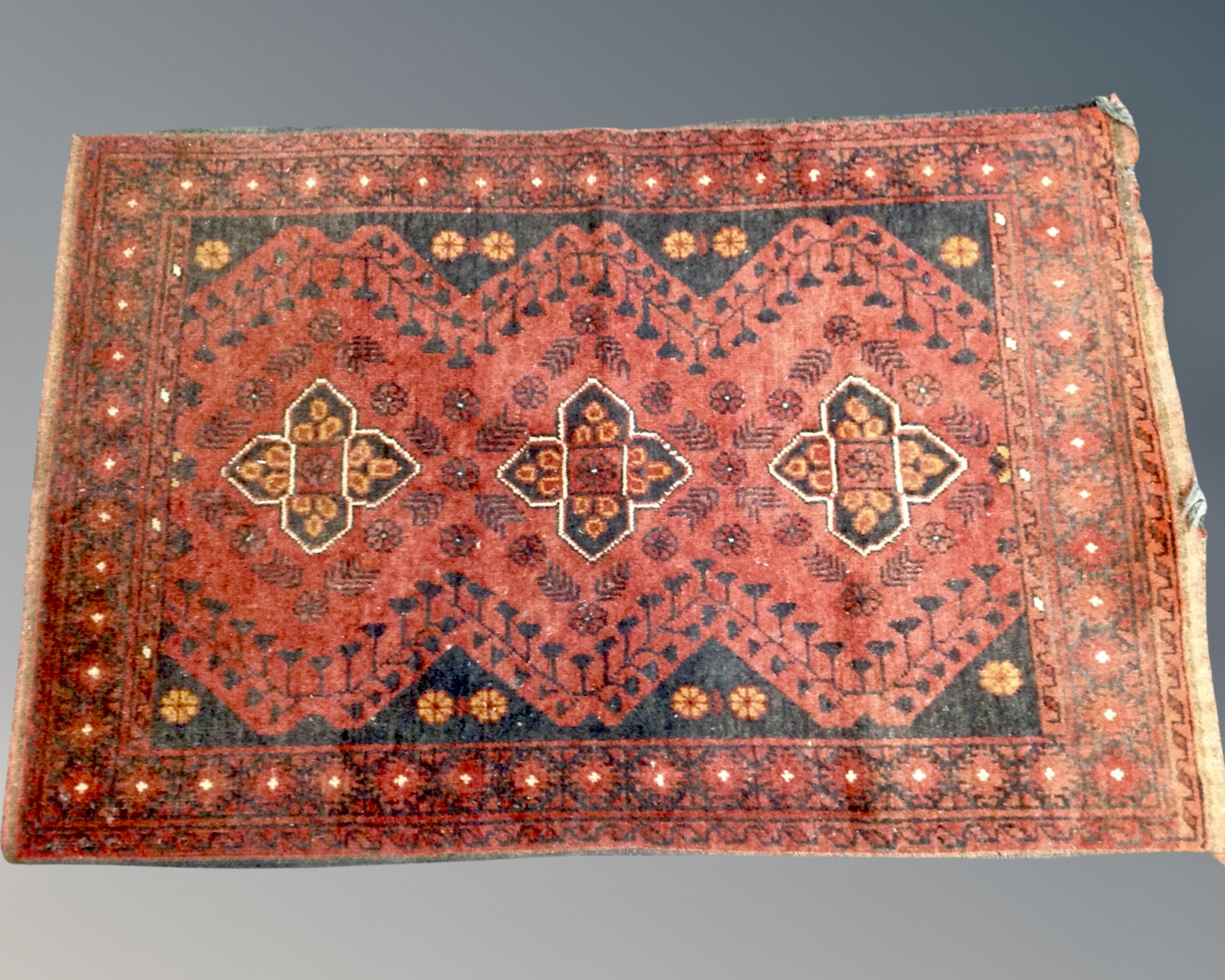 An Iranian woolen rug on red and black ground,