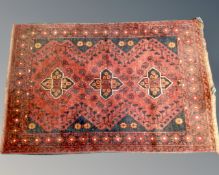 An Iranian woolen rug on red and black ground,