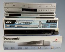 Three DVD players by Panasonic, JVC and Samsung, with remotes.