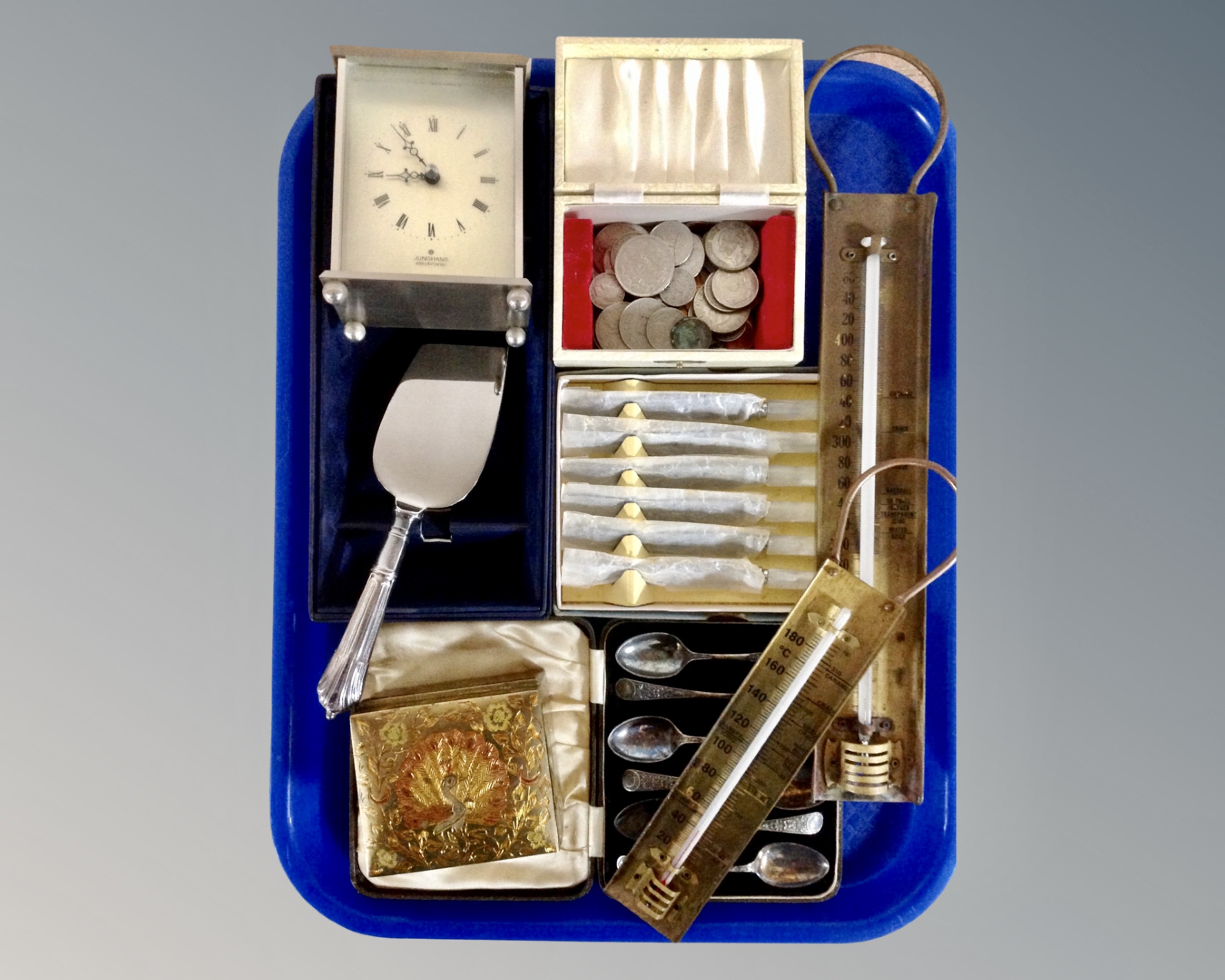 A tray of cased cutlery and server, brass thermometers,