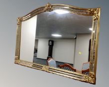 A contemporary arch top overmantel mirror in gilt and mirrored frame (width 128cm)