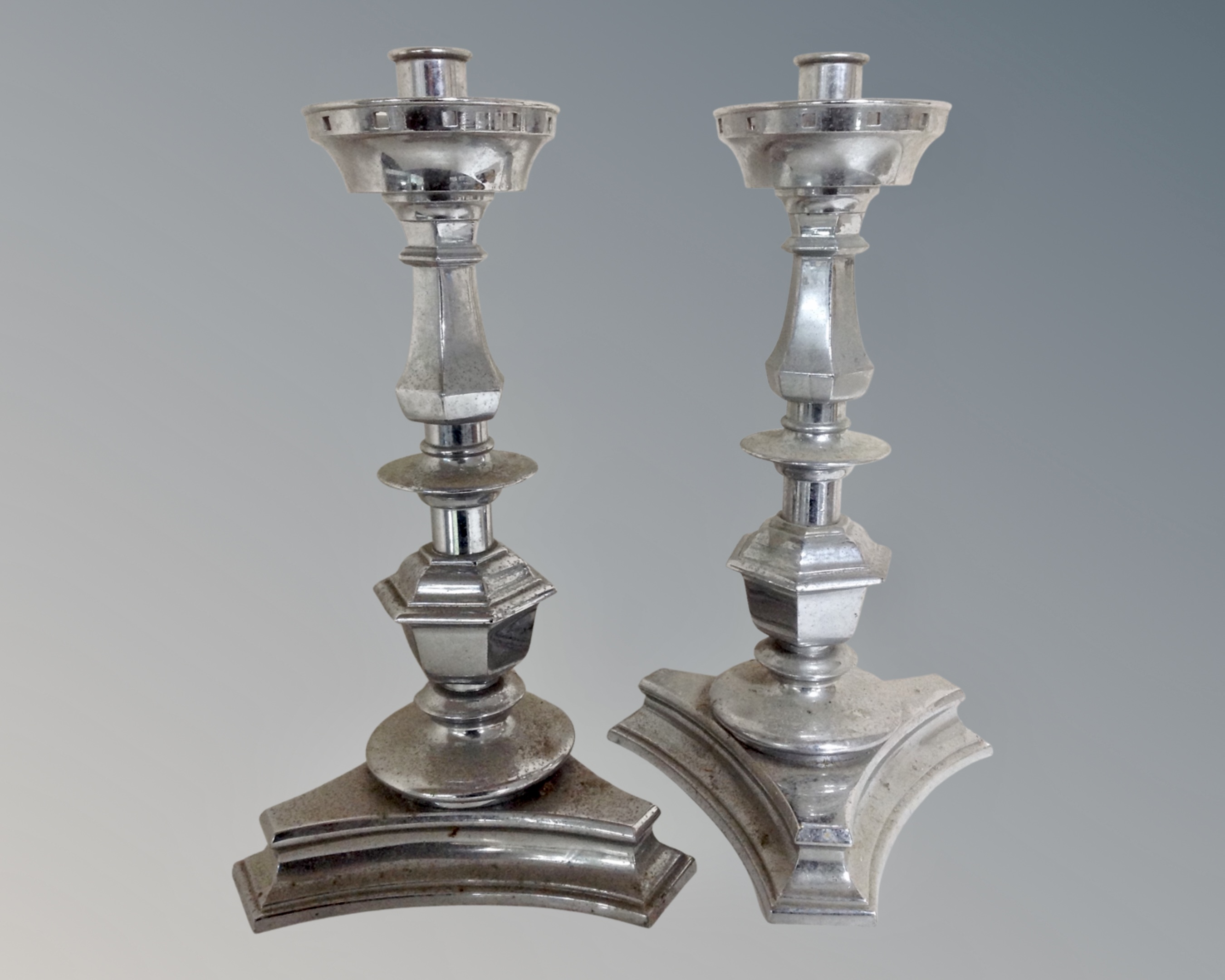 A pair of chromed candelabra.