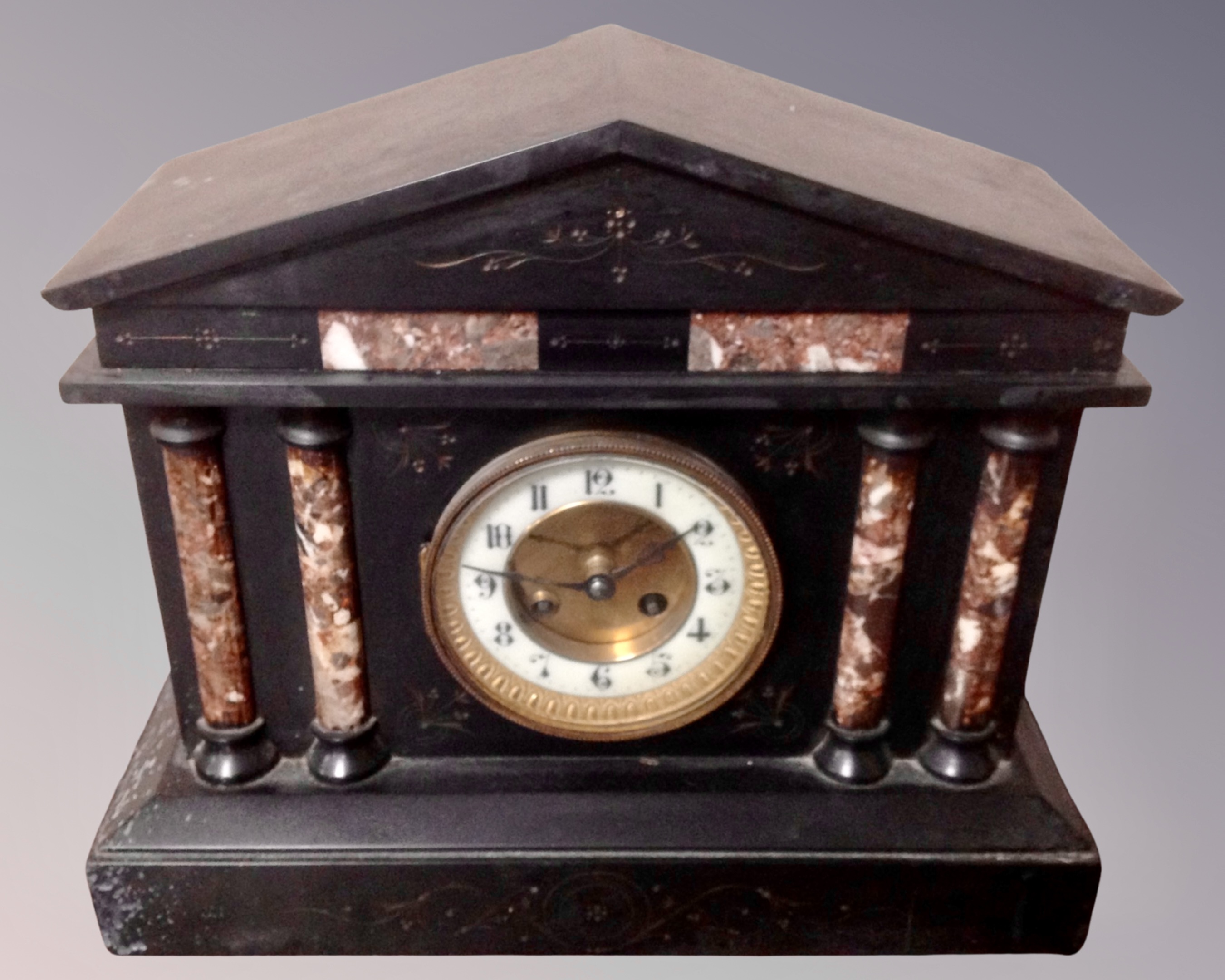 A Victorian slate and marble mantel clock.