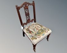 A 19th century carved mahogany bedroom chair with tapestry seat.