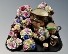 A tray containing china flower posies, Royal Doulton character jugs.