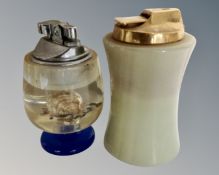 A resin table lighter with internal seashells together with a further Ronson table lighter.