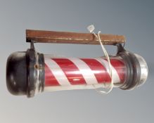 An electric barber's pole with bracket.