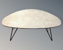 A contemporary 1970s style pebble coffee table on metal hairpin legs.