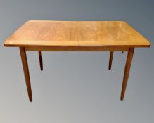 A Meredew teak extending dining table fitted with a leaf (length 182cm)