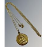 A yellow gold fine necklace with religious pendant, 5g.