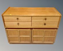 A 20th century Nathan teak double door cabinet fitted with four drawers above (width 102cm)