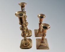 Two pairs of Victorian brass candlesticks.