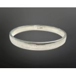 A circular silver bangle, diameter 61mm. CONDITION REPORT: 8.