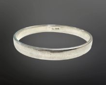 A circular silver bangle, diameter 61mm. CONDITION REPORT: 8.