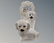 A pair of Victorian Staffordshire dogs together with a further Staffordshire group.