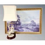 A gilt framed landscape print together with a continental table lamp.