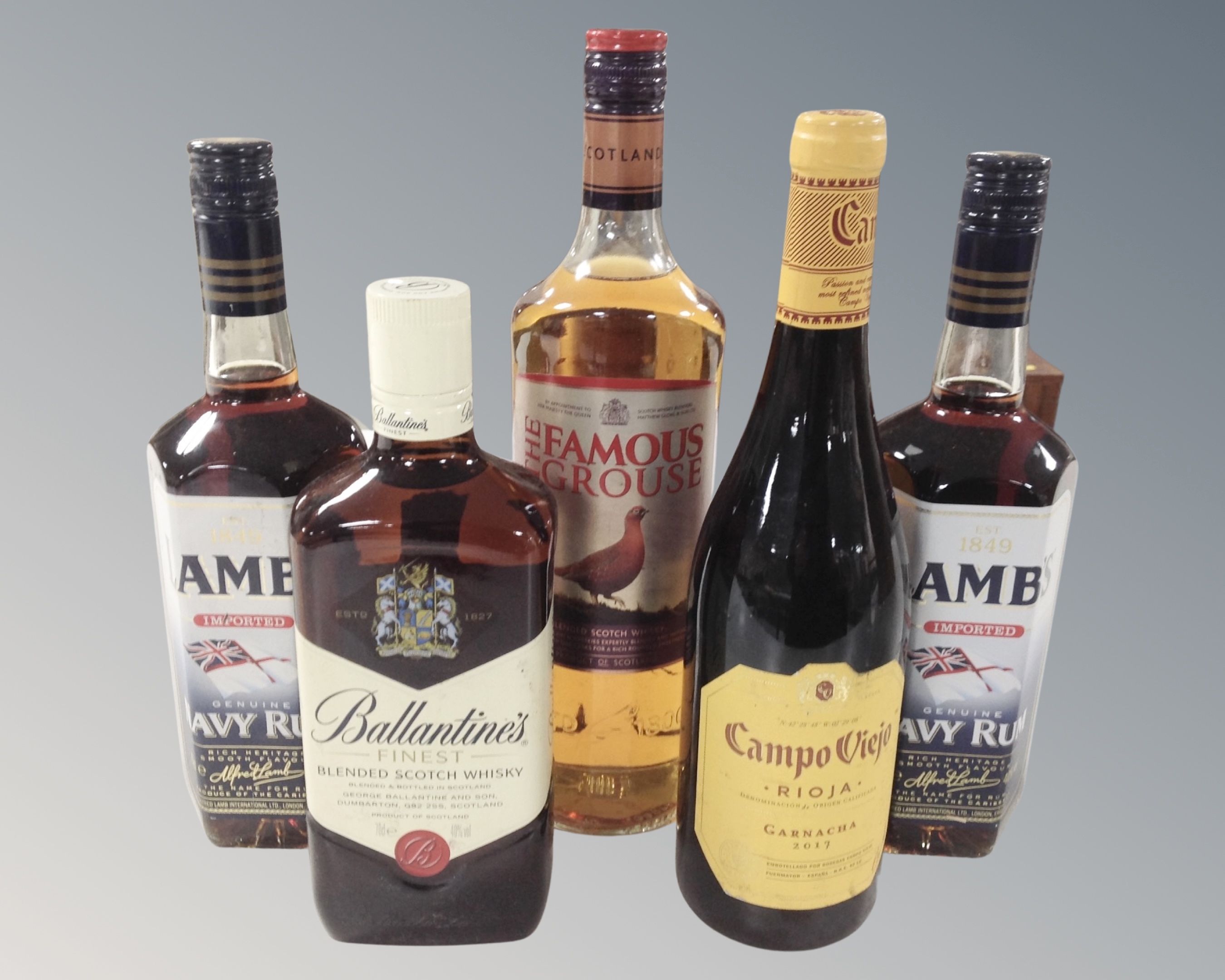 Two bottles of Lamb's Navy rum, bottle of Famous Grouse blended Scotch Whisky,